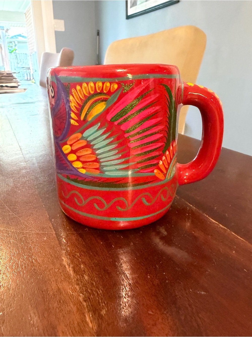 Hand-Painted Red Ceramic Mug with Colorful Feather Design - Cancun